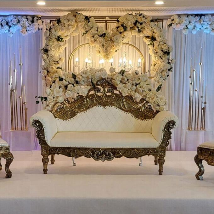 Wedding set up with white and gold gilded sofa