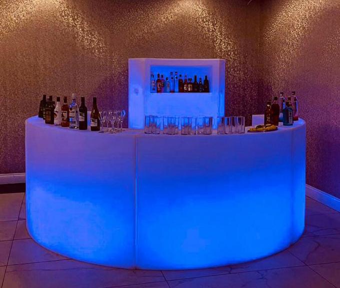 Lit up bar at wedding